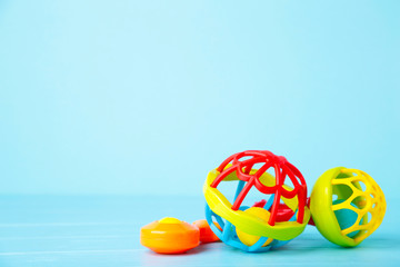 Colorful children's rattles on a blue background. Baby concept