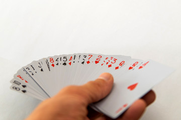 Playing cards in hand isolated on white background