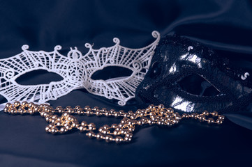 Carnival accessory on a black background. Masks and beads