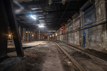 Big empty railway tunnel with many tracks near the underground railway station. Inside railway tunnel.