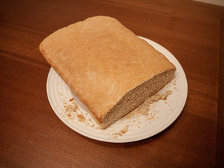 A brand new loaf of bread atop a table