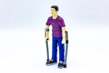 Isolated Disabled Young Man with Crutches. Good for Educational Purposes to Teach Children. Disability Toy Concept. Inclusive and Equal Opportunity Toy. - Photography