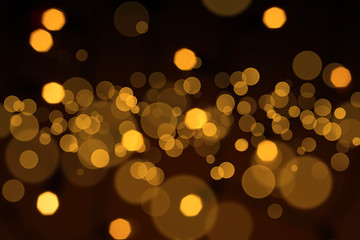 Golden defocused lights over black background