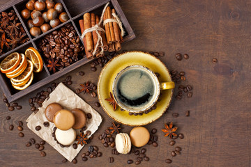 Coffee, chocolate and vanilla macarons on dark background