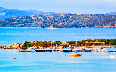 Landscape and scenery of Golfo Aranci atSardegna island in Italy in summer. Sassari province near Olbia and Cagliari. In Mediteranean sea. Yachts, boats and ships. Mixed media.