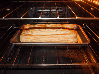 Pie crust inside oven close up during cooking yum