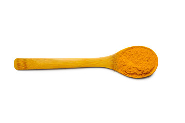 Dry turmeric powder and wooden spoon on  isolated white background.Close-up of powder orange color turmeric.top view