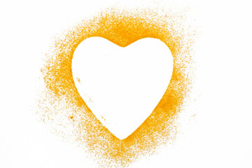 Heart turmeric powder isolated on white background.Close-up of powder orange color turmeric.top view