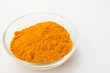 Dry turmeric powder isolated on white background.Close-up of powder orange color turmeric.