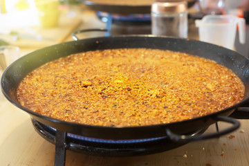Paella pan with traditional Spanish food usually prepared with rice, meat, seafood. Horizontal orientation