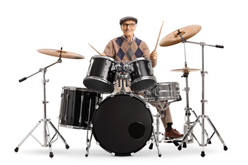 Fototapeta na wymiar Senior man playing on a drum kit
