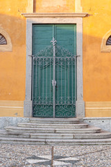 green door of church entrance with gate, Italy Europe