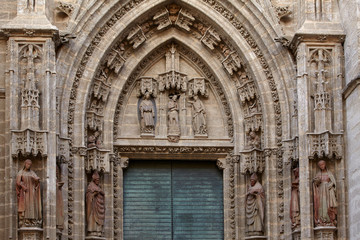 Fototapeta na wymiar Detail of the portal of the cathedral Saint Mary of the See, Seville, Spain