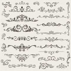Obraz premium Vector set of calligraphic design elements and page decorations. Elegant collection of hand drawn swirls and curls for your design. Isolated on beige background