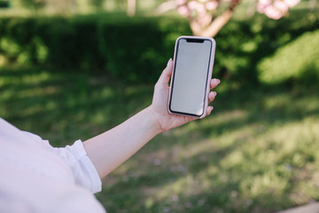 Mock up woman hold smartphone in left hand