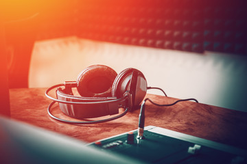 Headphones in radio station studio, close up.