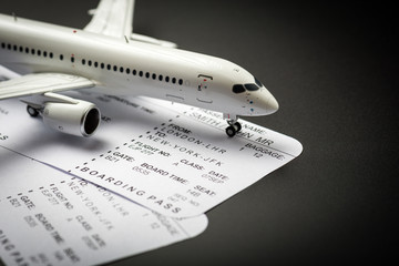 Toy Airplane with boarding pass or ticket - main trave traveller outfit. Fly travelling concept. Summer travel © bychykhin