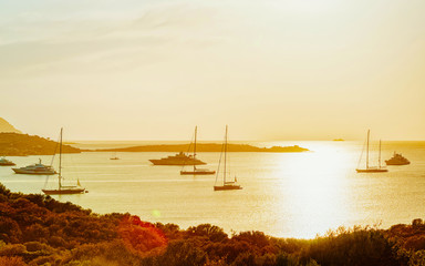 Sunrise or sunset with yachts at Porto Rotondo on at Mediterranean sea in Sardinia island of Italy....