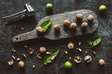 Walnuts on dark vintage table. healthy food. Old vintage table and leaves from the nut.