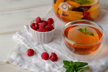 Fruit hot tea with the addition of oranges, lemons, raspberries and mint