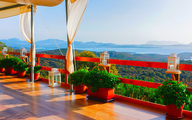 Sunrise or sunset at Cafe or Restaurant veranda near Porto Rotondo on at Mediterranean sea in...