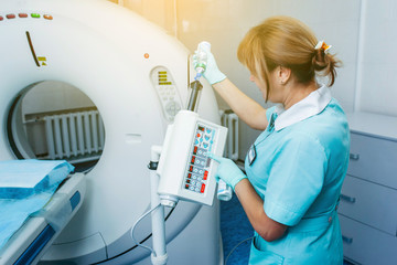 Doctor prepares automatic dual shot syringe for high tech ct scanner