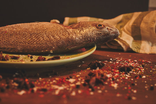 Fresh sea fish over green plate