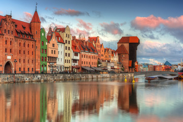 Fototapeta premium Beautiful scenery of the old town in Gdansk over Motlawa river at sunrise, Poland.