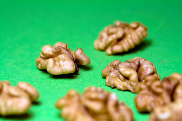 Walnuts on green background