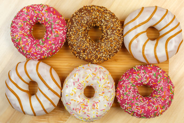 Glazed donuts on a wooden background