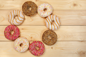 Glazed donuts on a wooden background