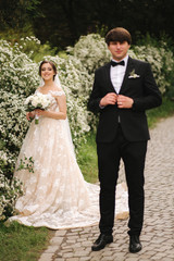 Handsome groom staind in front of beutiful bride