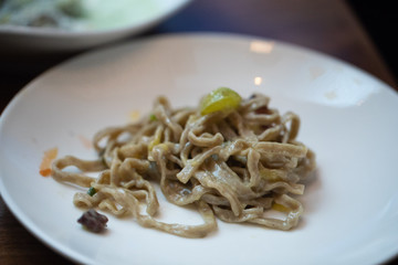Homemade wheat fetuccini with cream sauce and egg