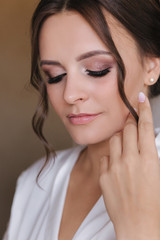 Close up portrait of gorgeous bride at hotel in morning. Charming woman with great hairstyle and makeup