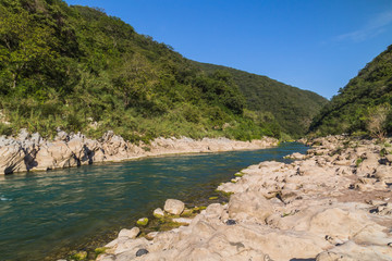 Fototapeta premium Amazing crystalline blue water of Tamul waterfall, Close up view of spectacular Tamul River,at Huasteca Potosina in San Luis Potosi, Mexico