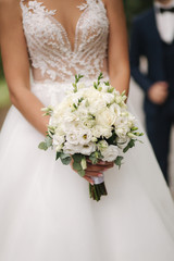 Bride hold wedding bouquet of flowers in hands