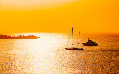 Sunrise or sunset with yachts at Porto Rotondo on at Mediterranean sea in Sardinia island of Italy....