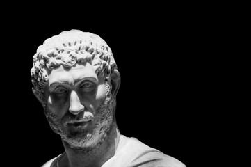 Black and white photo of classical roman statue male face