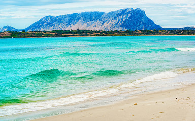 Landscape with La Cinta beach and Mediterranean Sea and Tavolara Island in Sardinia on Italy in...