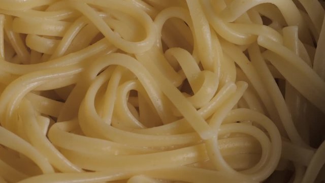 Close up texture shot of cooked spaghetti noodles plain.