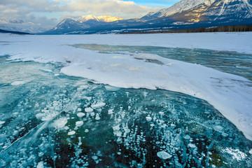 Trapped methane bubbles frozen into the water under the thick cracked and folded ice on Abraham...