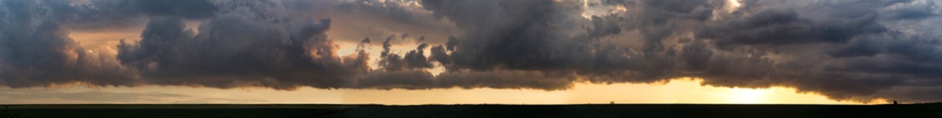 Leaden, storm clouds covered the sunset. Cumuliform cloudscape on blue sky. The terrain in southern Europe. Fantastic skies on the planet earth. Tragic gloomy sky..
