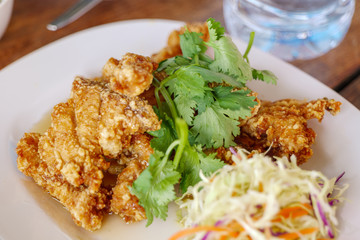 Deep fried fish meats, Thai style  meal snapper topped with spicy sauce on side.