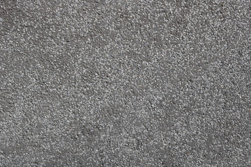 flat gray cement surface with embedded pebbles background texture