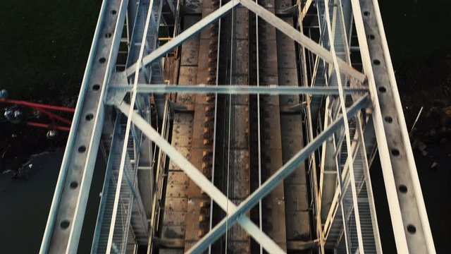 Aerial view of a drone on a railway metal bridge