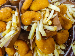 Chicken fried nuggets and fried potato, close-up