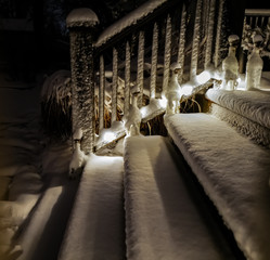 fresh snowfall on the backyard deck at night