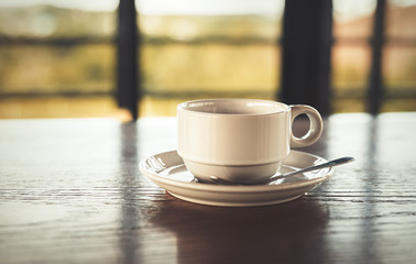 A cup of coffee on the table.