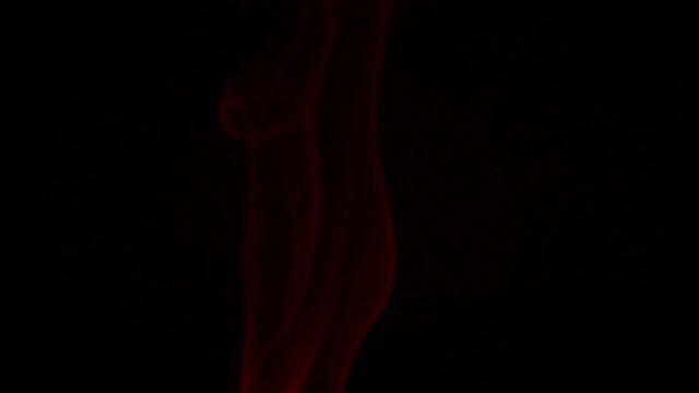 Abstract raising red smoke on black background in slow motion