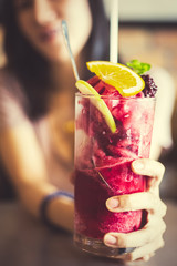 Women hold mulberry smoothie. Mulberry, Lemon and Mint in smoothie.